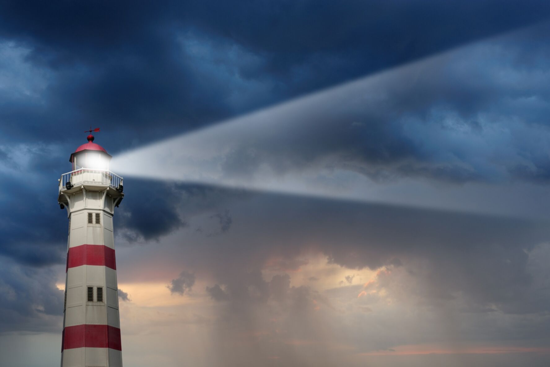Teilweise sonnendurchflutete Leuchtturm, schlechtes Wetter im Hintergrund